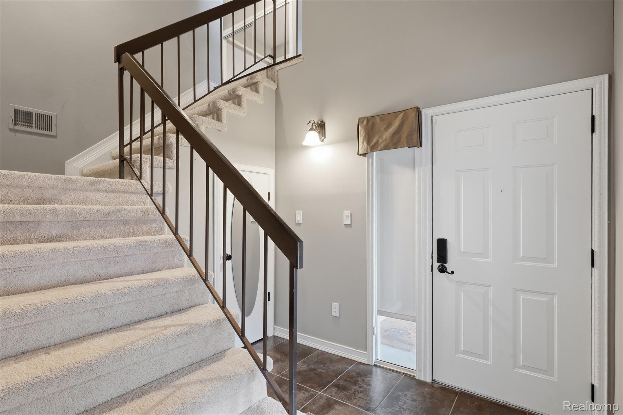 29726 Pine Ridge Circle Farmington, MI 48331 - Photo 5 of 40 Entry foyer featuring a multi-panel door with smart lock