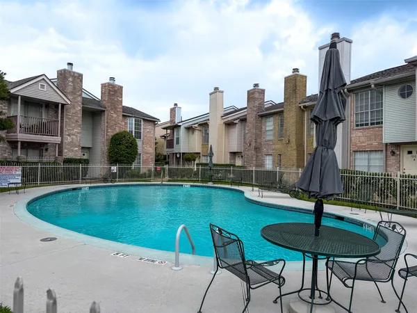 a view of a house with swimming pool and sitting area