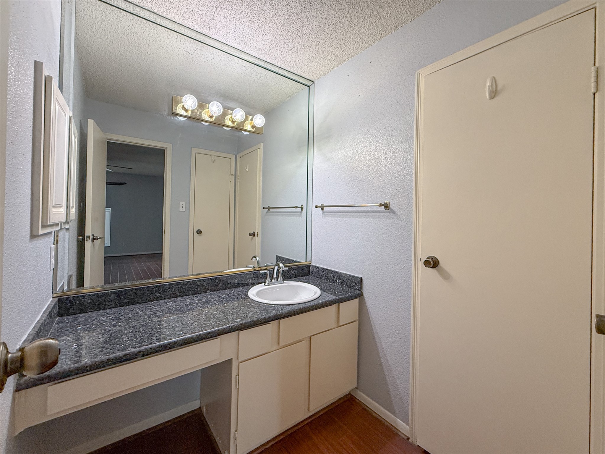 3100 Jeanetta Street, Unit 1104 Houston, TX 77063 - Photo 11 of 19 a bathroom with a granite countertop sink and a mirror