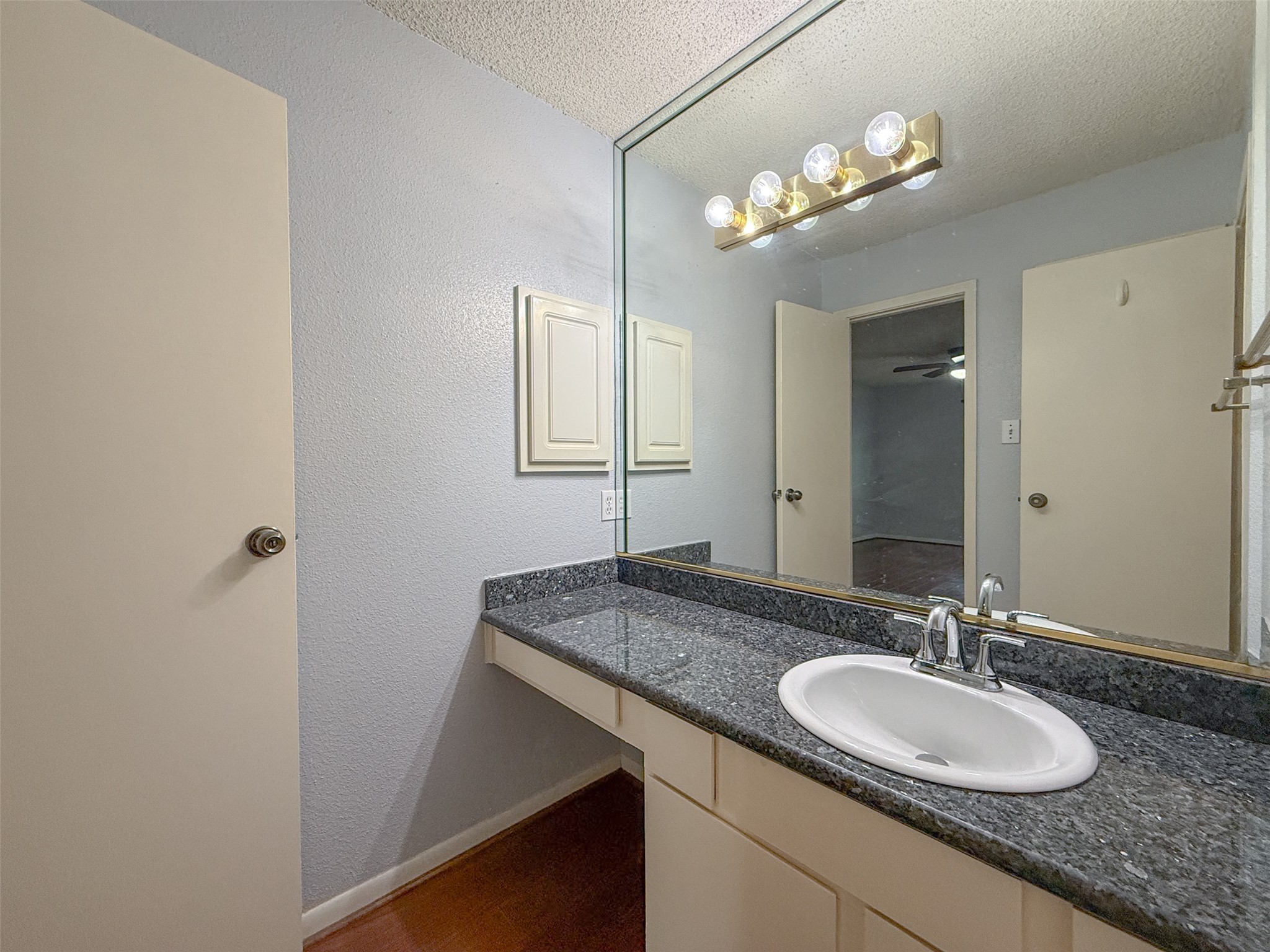 3100 Jeanetta Street, Unit 1104 Houston, TX 77063 - Photo 13 of 19 a bathroom with a granite countertop sink a light fixture and a mirror