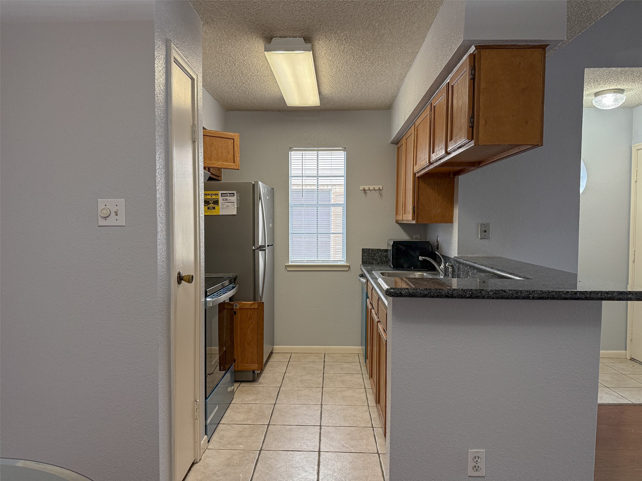 3100 Jeanetta Street, Unit 1104 Houston, TX 77063 - Photo 3 of 19 a kitchen with a sink and cabinets