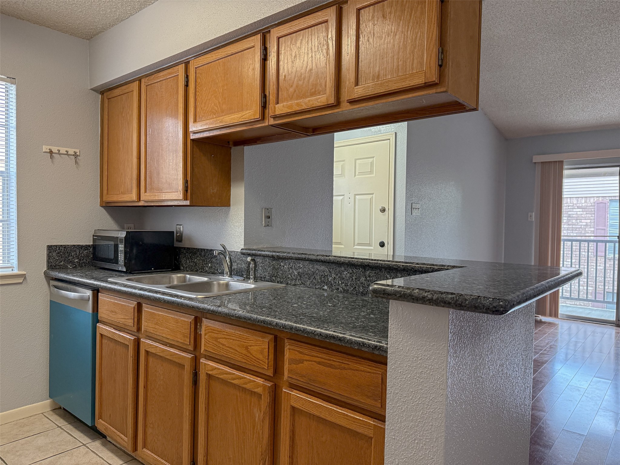 3100 Jeanetta Street, Unit 1104 Houston, TX 77063 - Photo 5 of 19 a kitchen with granite countertop stainless steel appliances a sink and cabinets