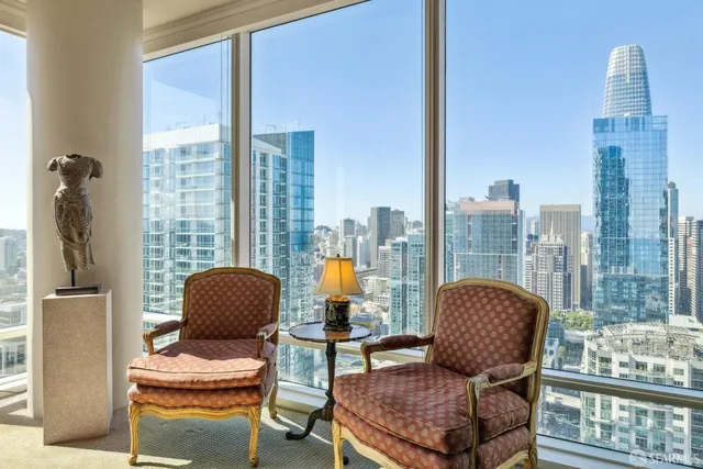 a living room with furniture and a floor to ceiling window