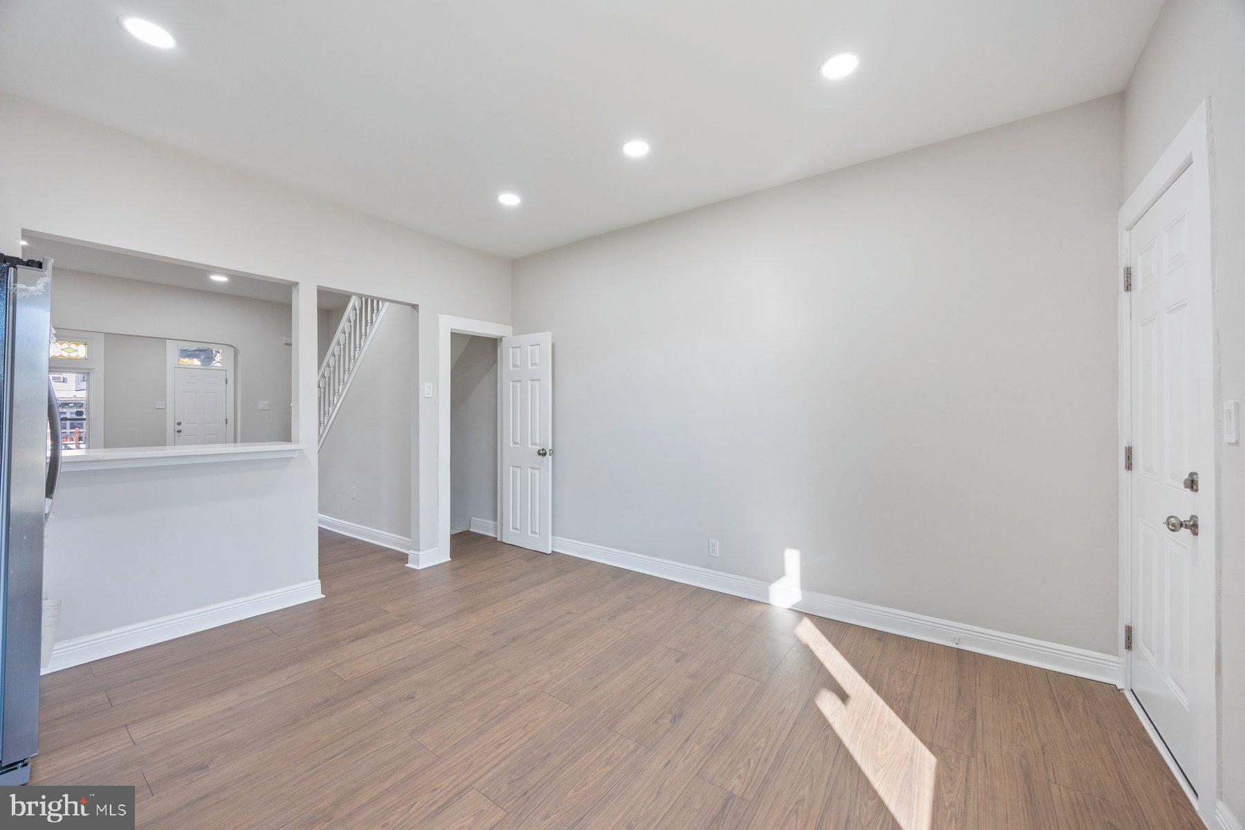 117 Collins Avenue Baltimore, MD 21229 - Photo 11 of 27 wooden floor in an empty room with a window