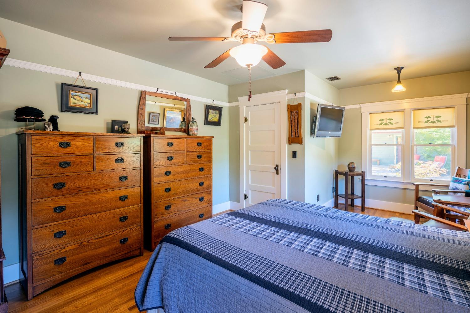 46 Pollasky Avenue Clovis, CA 93612 - Photo 25 of 69 a bedroom with a bed and a chandelier