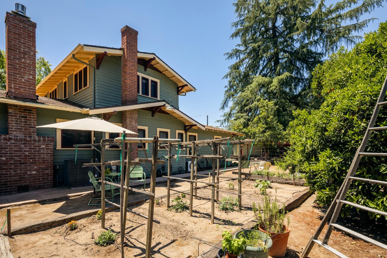 46 Pollasky Avenue Clovis, CA 93612 - Photo 44 of 69 a front view of a house with table and chairs