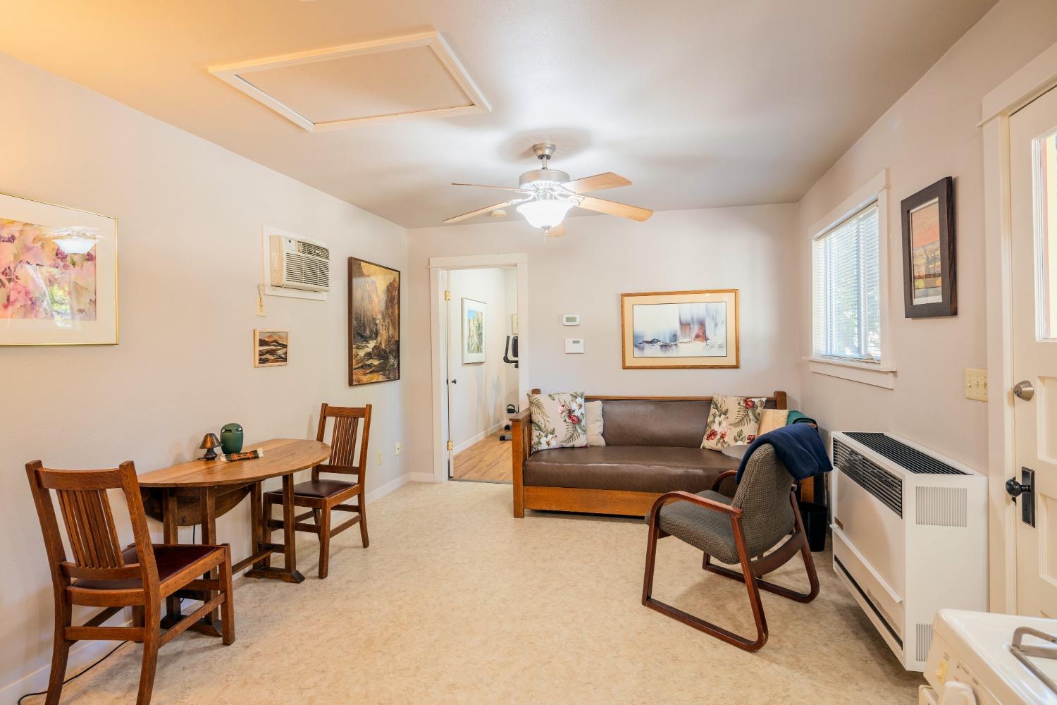 46 Pollasky Avenue Clovis, CA 93612 - Photo 49 of 69 a living room with furniture and a dining table with wooden floor