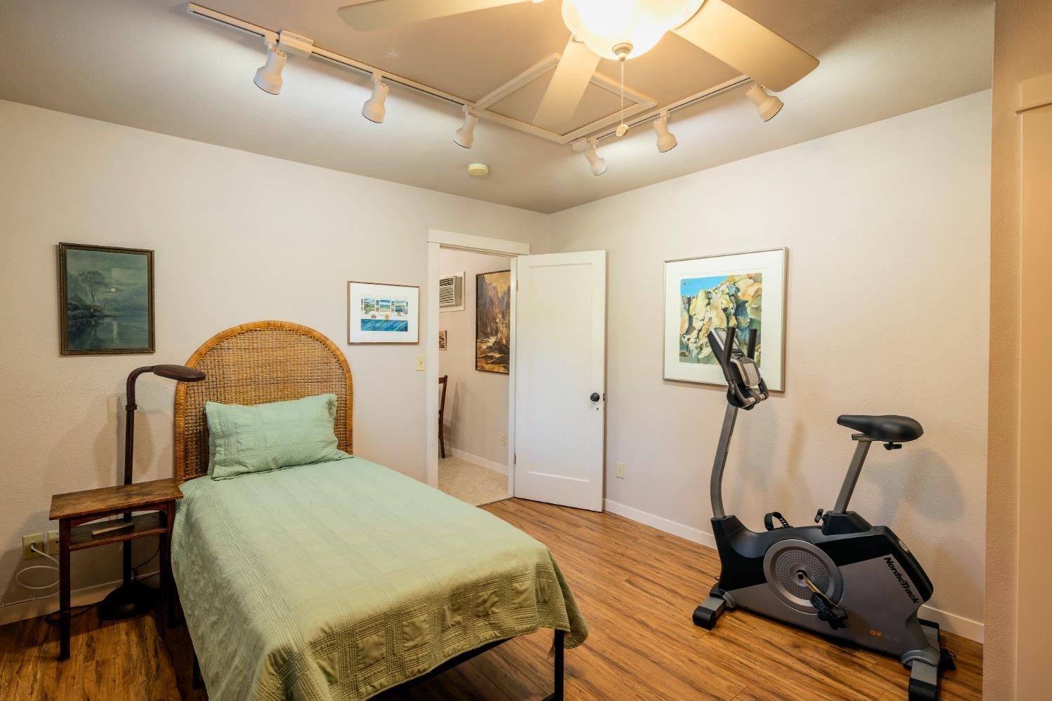 46 Pollasky Avenue Clovis, CA 93612 - Photo 55 of 69 a bedroom with a bed and wooden floor