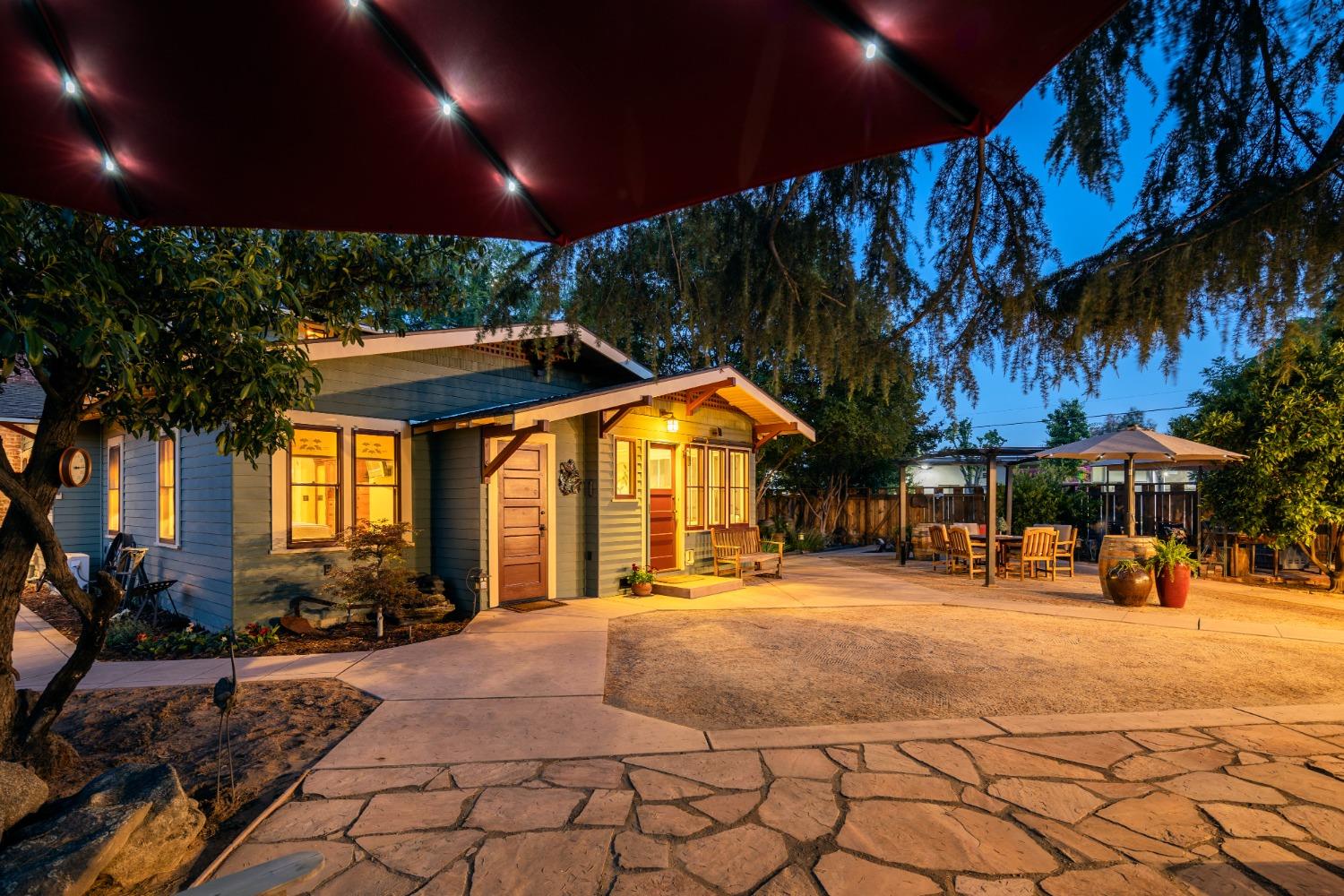46 Pollasky Avenue Clovis, CA 93612 - Photo 57 of 69 a view of a yard with table and chairs under an umbrella with a patio