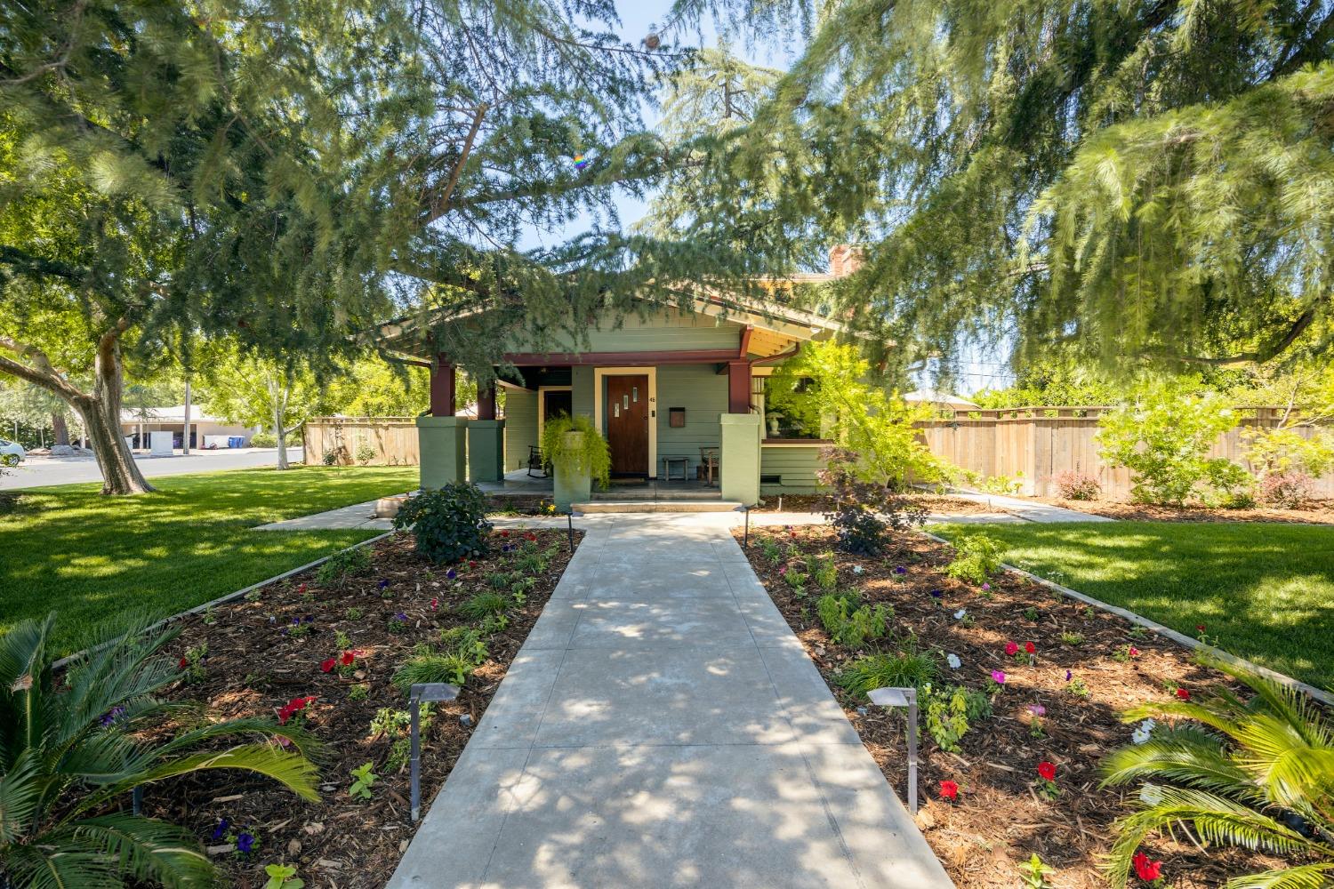 46 Pollasky Avenue Clovis, CA 93612 - Photo 6 of 69 a front view of a house with a yard and potted plants