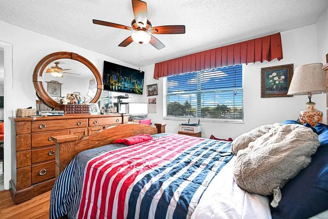 a bedroom with a large bed and a large window