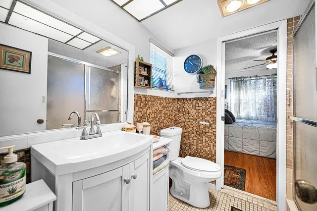 a bathroom with a sink toilet and shower