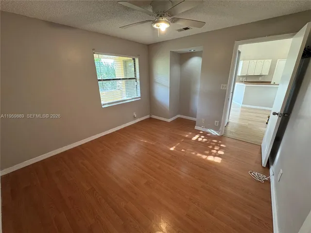 an empty room with windows and closet