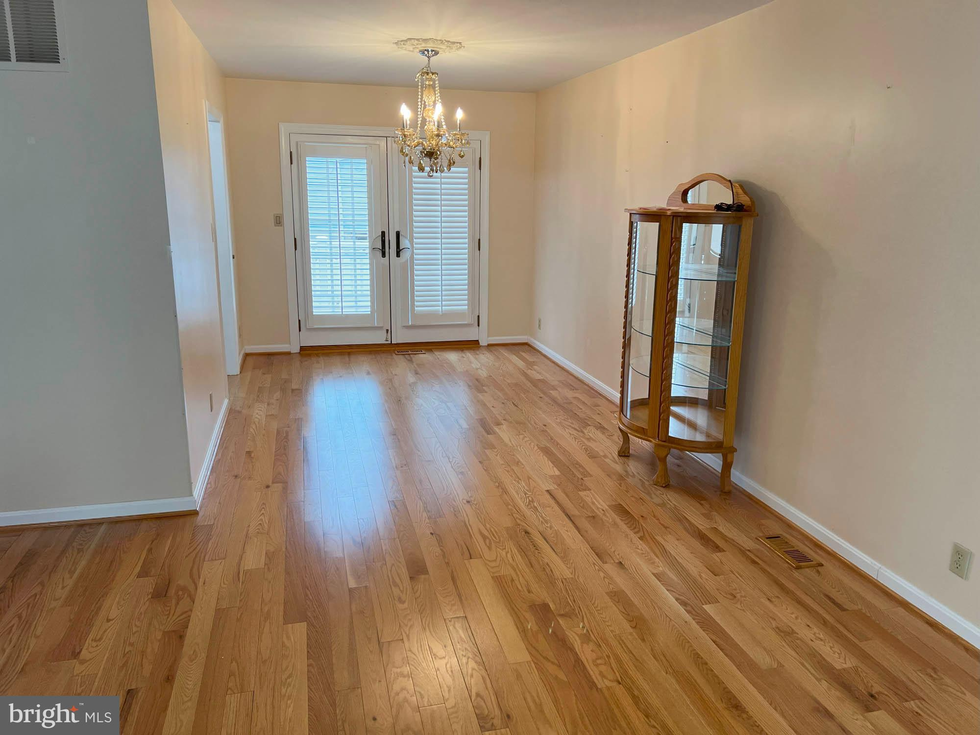 7024 Sollers Point Road Baltimore, MD 21222 - Photo 6 of 22 wooden floor in an empty room with a window