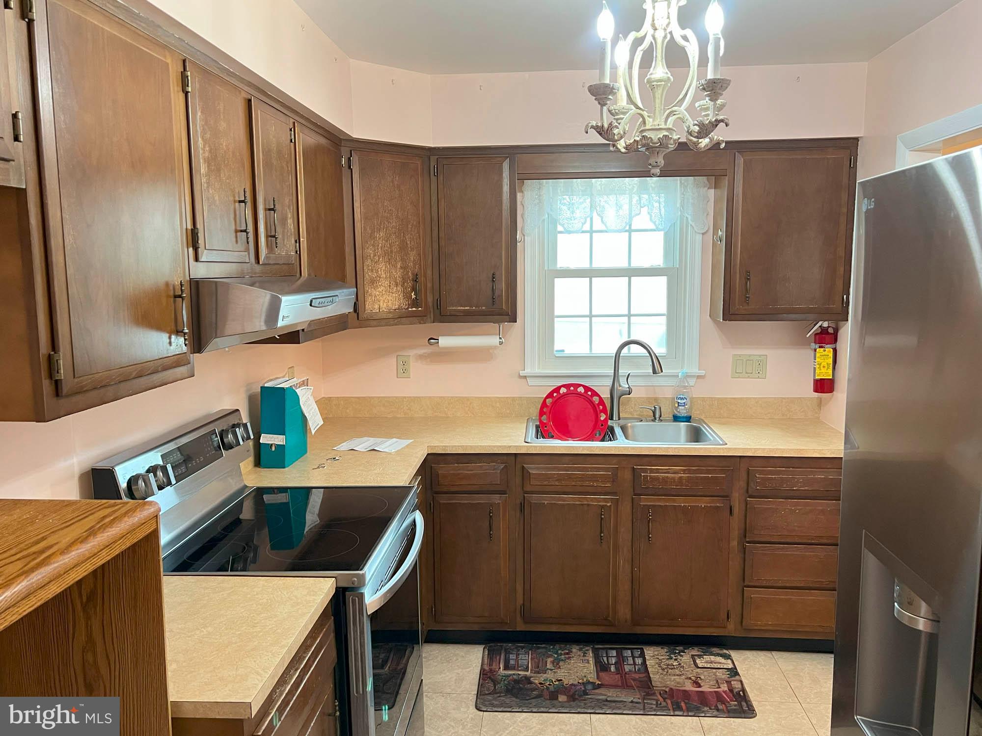 7024 Sollers Point Road Baltimore, MD 21222 - Photo 7 of 22 a kitchen with stainless steel appliances a sink stove and refrigerator