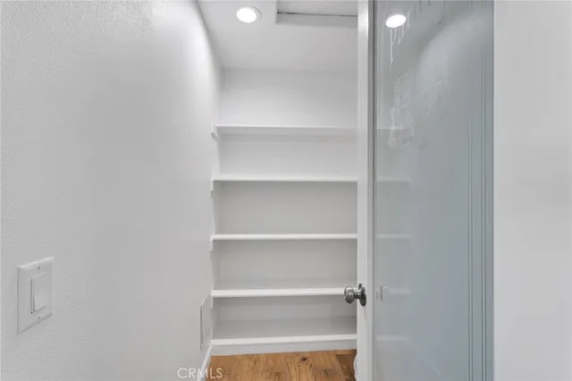 an empty room with a ceiling fan and window