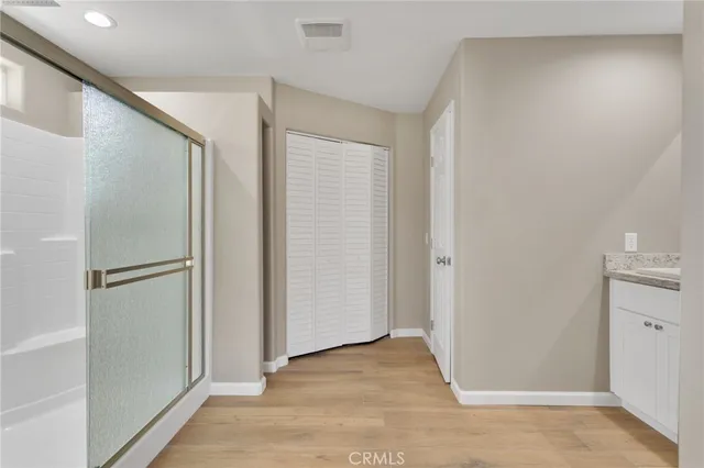 a view of a hallway with wooden shelves