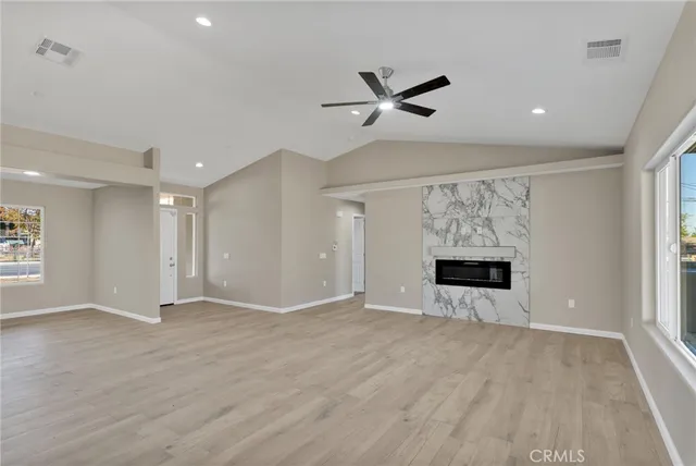 a large kitchen with cabinets wooden floor and a fireplace