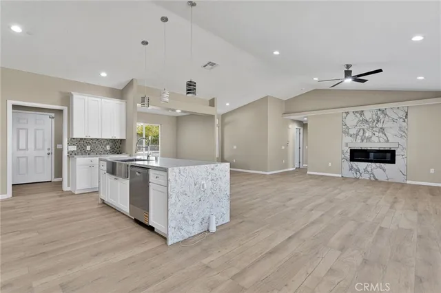 a view of a kitchen with a sink and wooden floor
