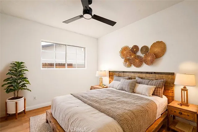 a bedroom with a bed and a potted plant