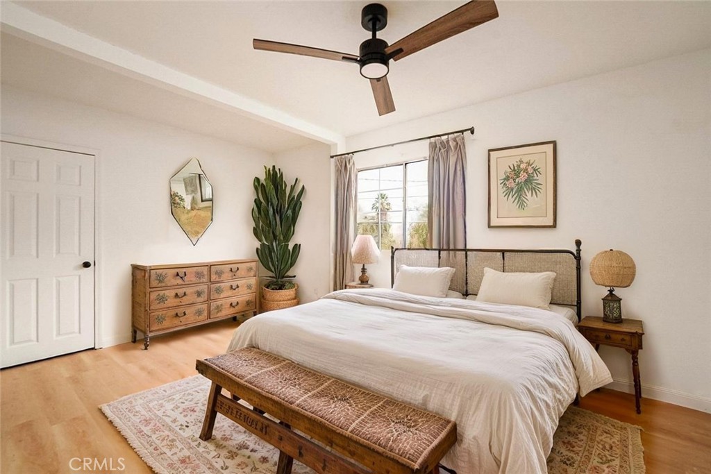 522 Price Street Bakersfield, CA 93307 - Photo 14 of 23 a bedroom with a bed a dresser with wooden floor