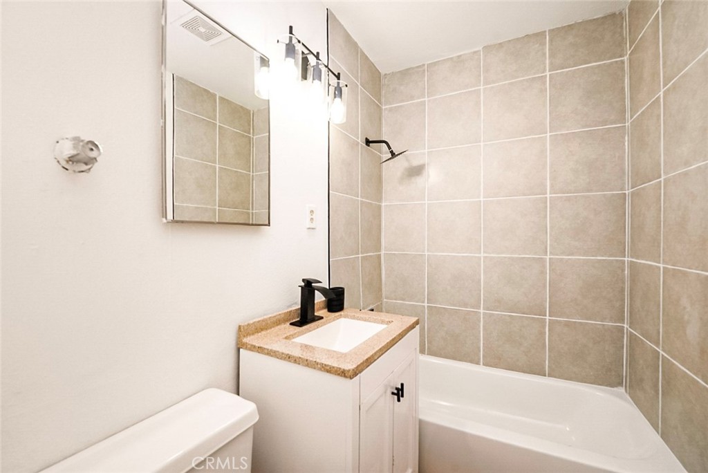 522 Price Street Bakersfield, CA 93307 - Photo 17 of 23 a bathroom with a sink a toilet and shower