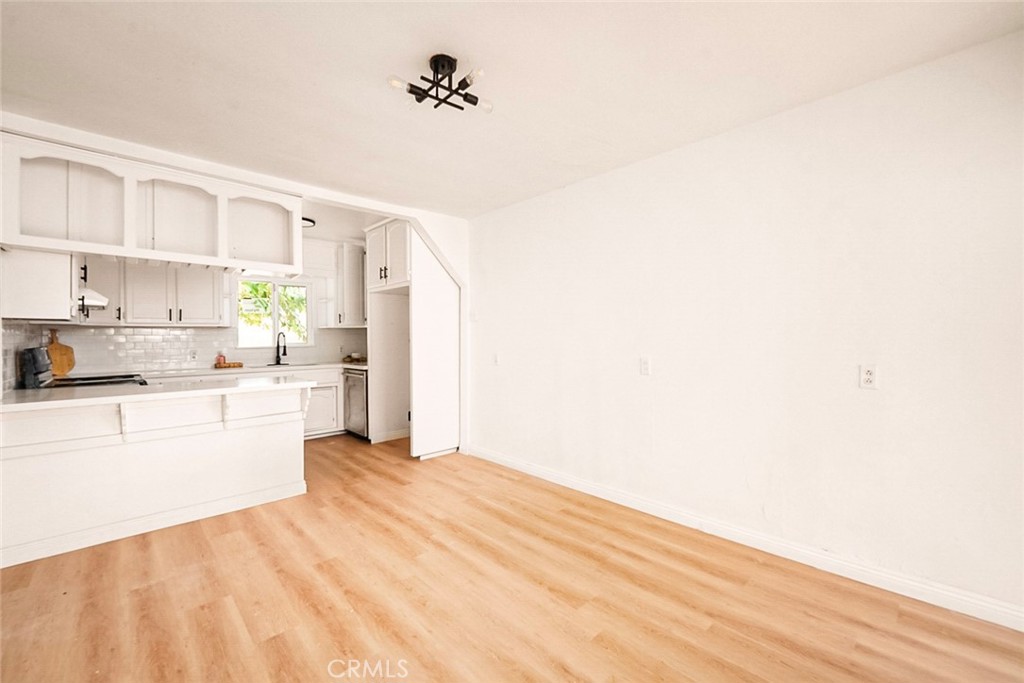 522 Price Street Bakersfield, CA 93307 - Photo 5 of 23 a kitchen with granite countertop white cabinets and white appliances