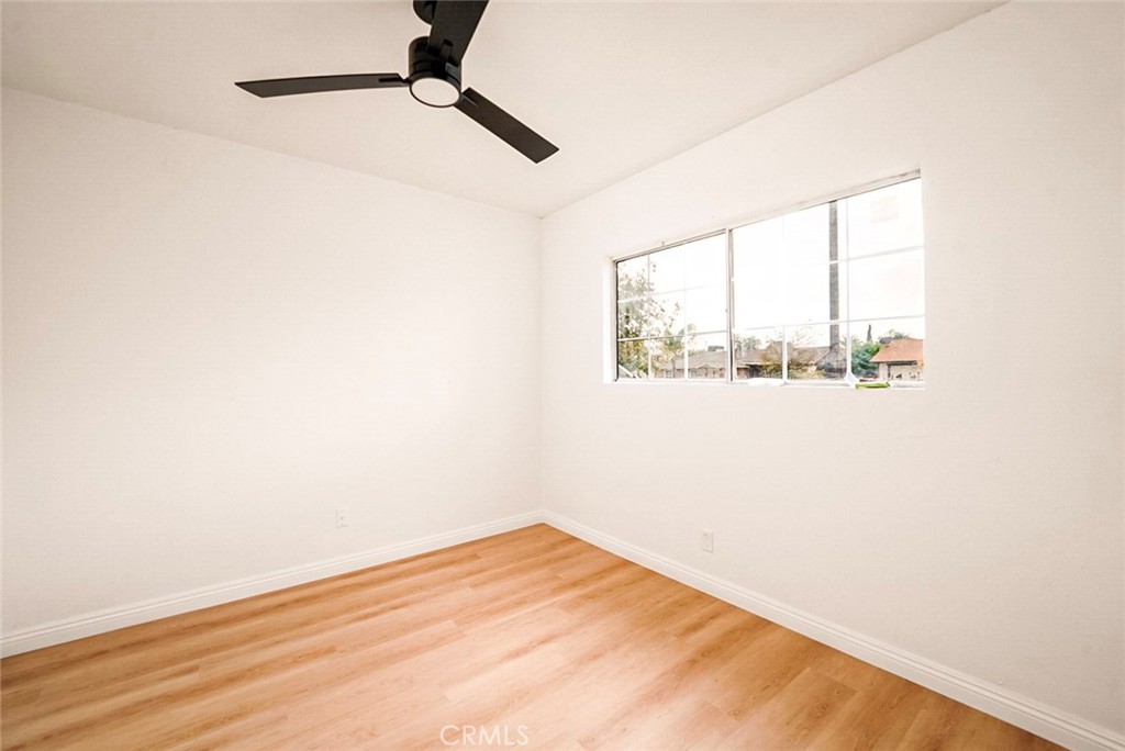 522 Price Street Bakersfield, CA 93307 - Photo 9 of 23 a view of empty room with wooden floor and fan