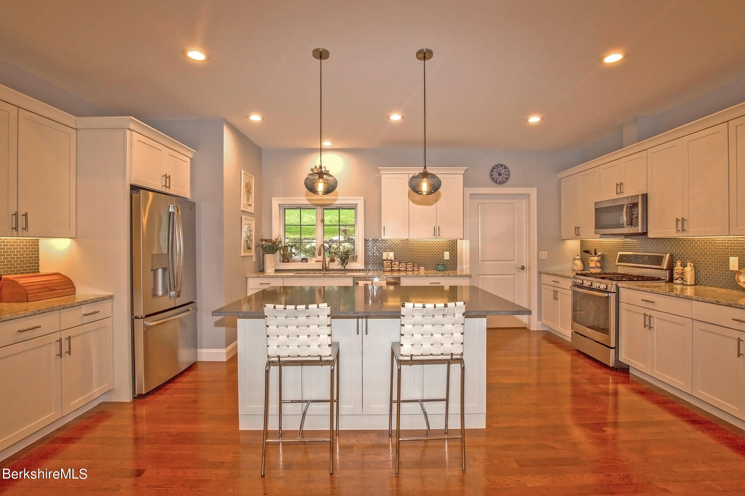 3 Burning Tree Road Great Barrington, MA 01230 - Photo 11 of 50 a kitchen with stainless steel appliances kitchen island granite countertop a refrigerator a stove top oven and a view of living room