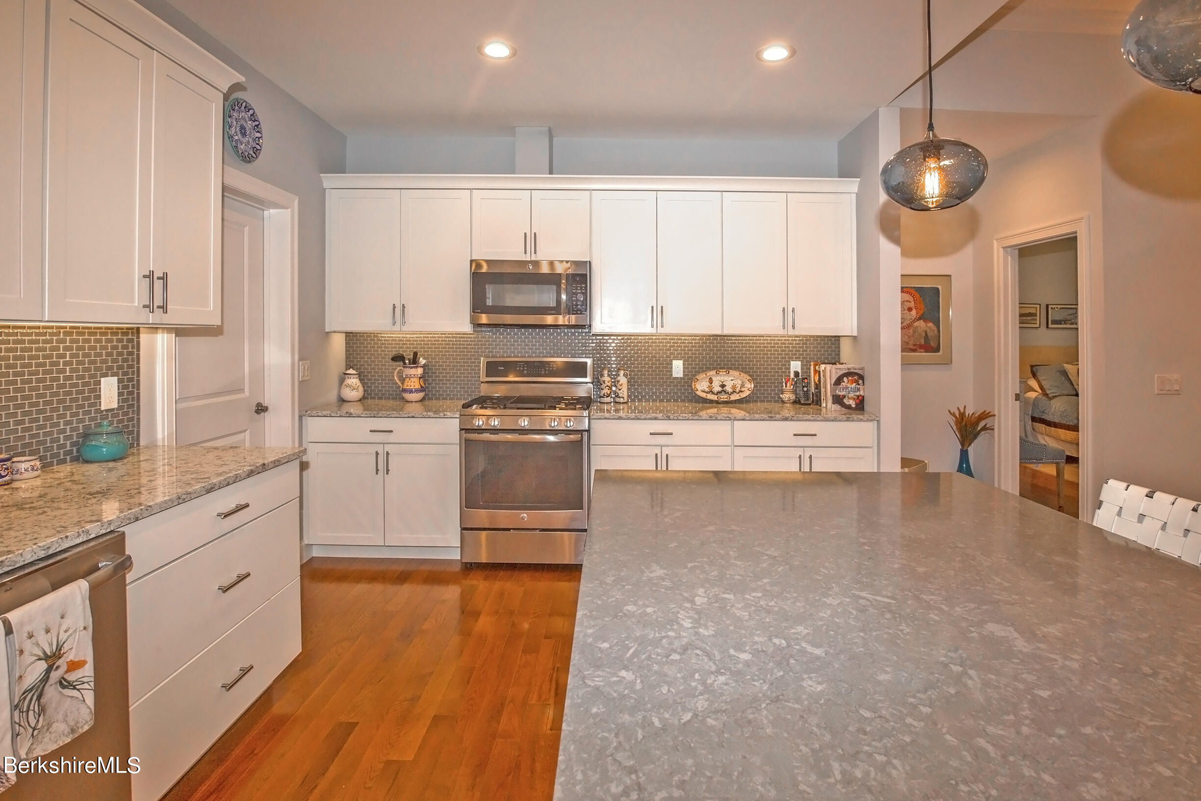 3 Burning Tree Road Great Barrington, MA 01230 - Photo 13 of 50 a kitchen with stainless steel appliances kitchen island granite countertop a sink a stove and cabinets