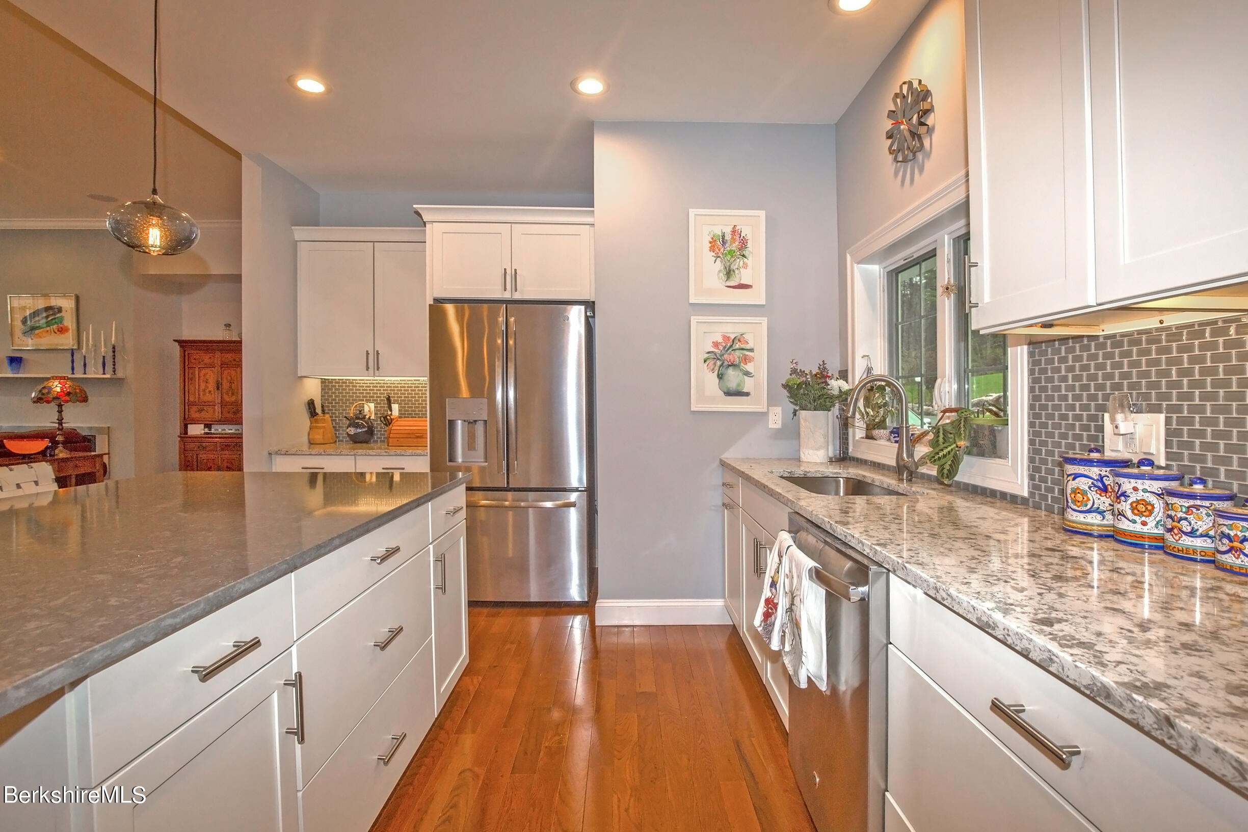 3 Burning Tree Road Great Barrington, MA 01230 - Photo 14 of 50 a kitchen with stainless steel appliances granite countertop a refrigerator a sink dishwasher a oven and a dining table with wooden floor