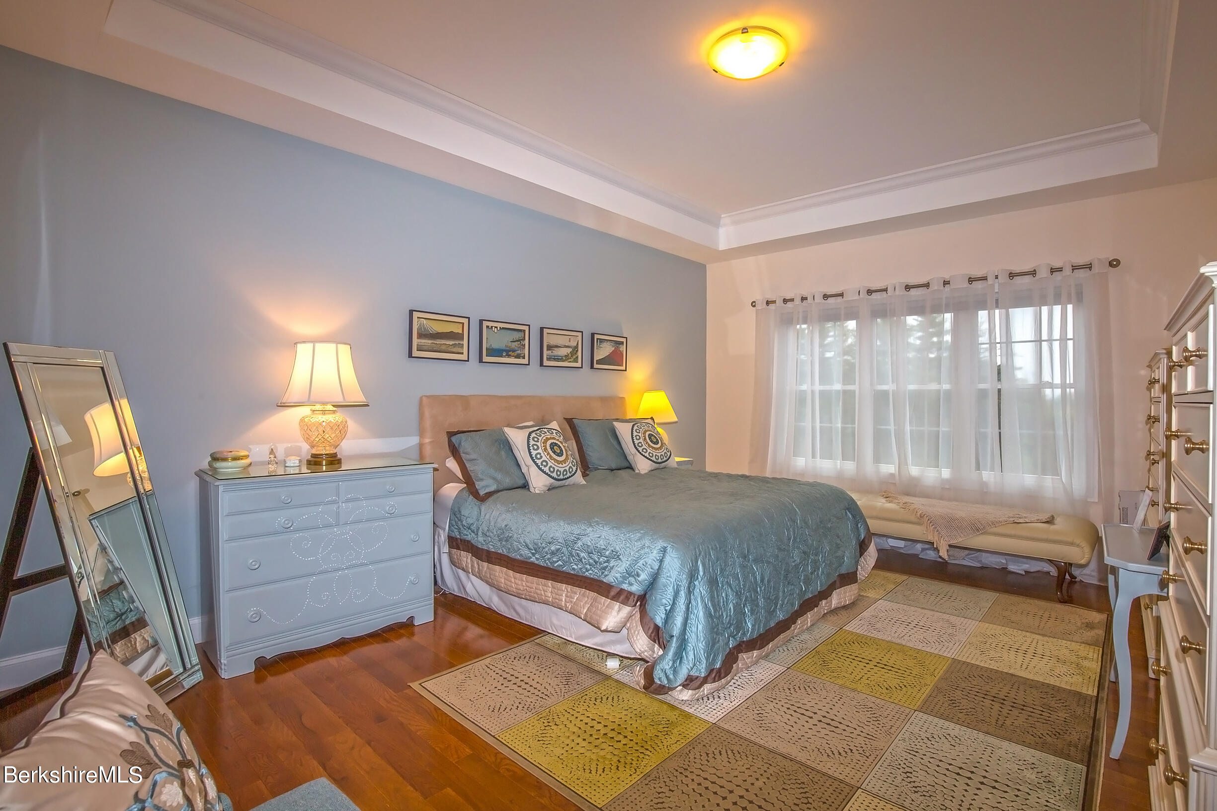 3 Burning Tree Road Great Barrington, MA 01230 - Photo 18 of 50 a bedroom with a bed and a lamp on dresser