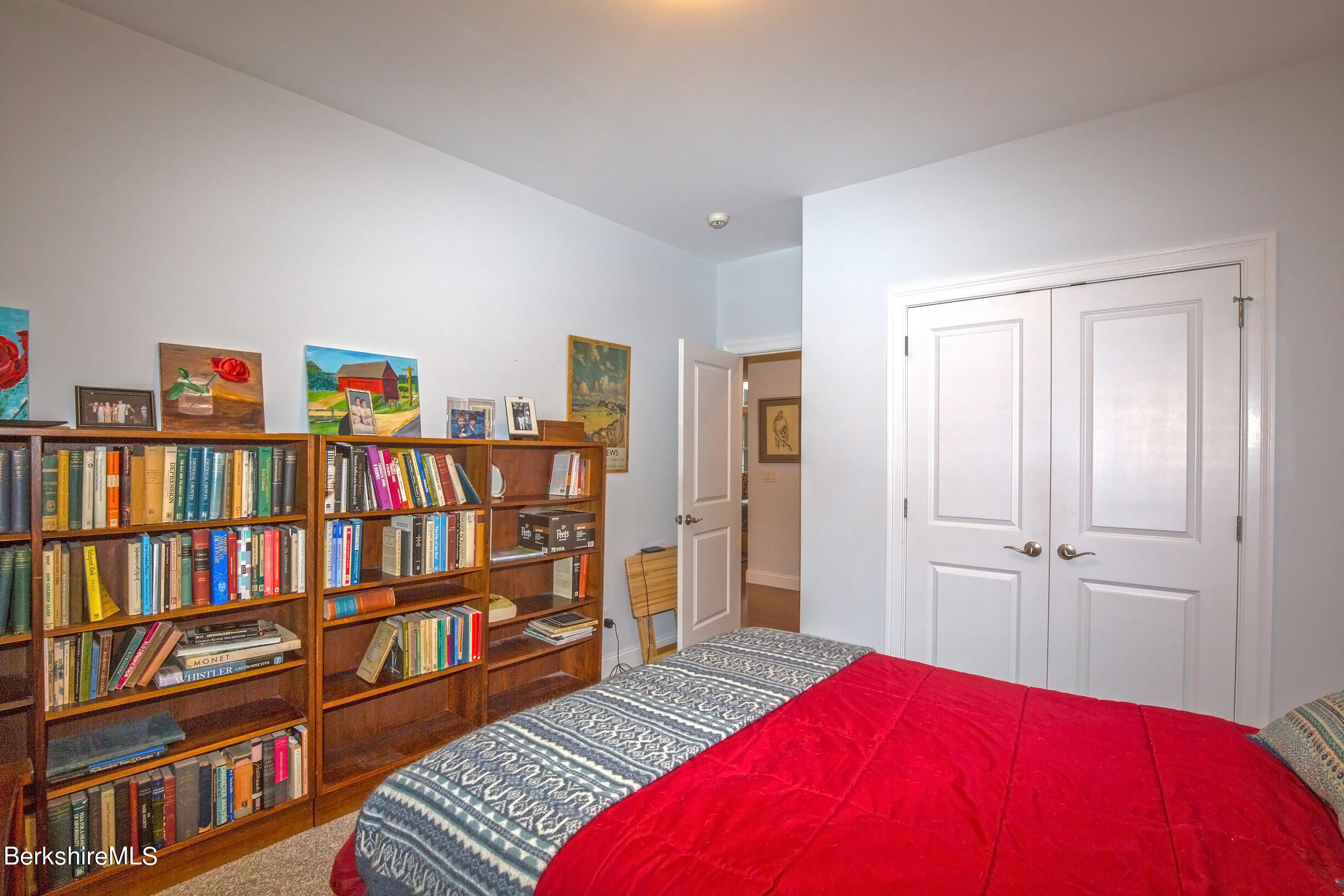 3 Burning Tree Road Great Barrington, MA 01230 - Photo 26 of 50 a bedroom with a bed furniture and a book shelf
