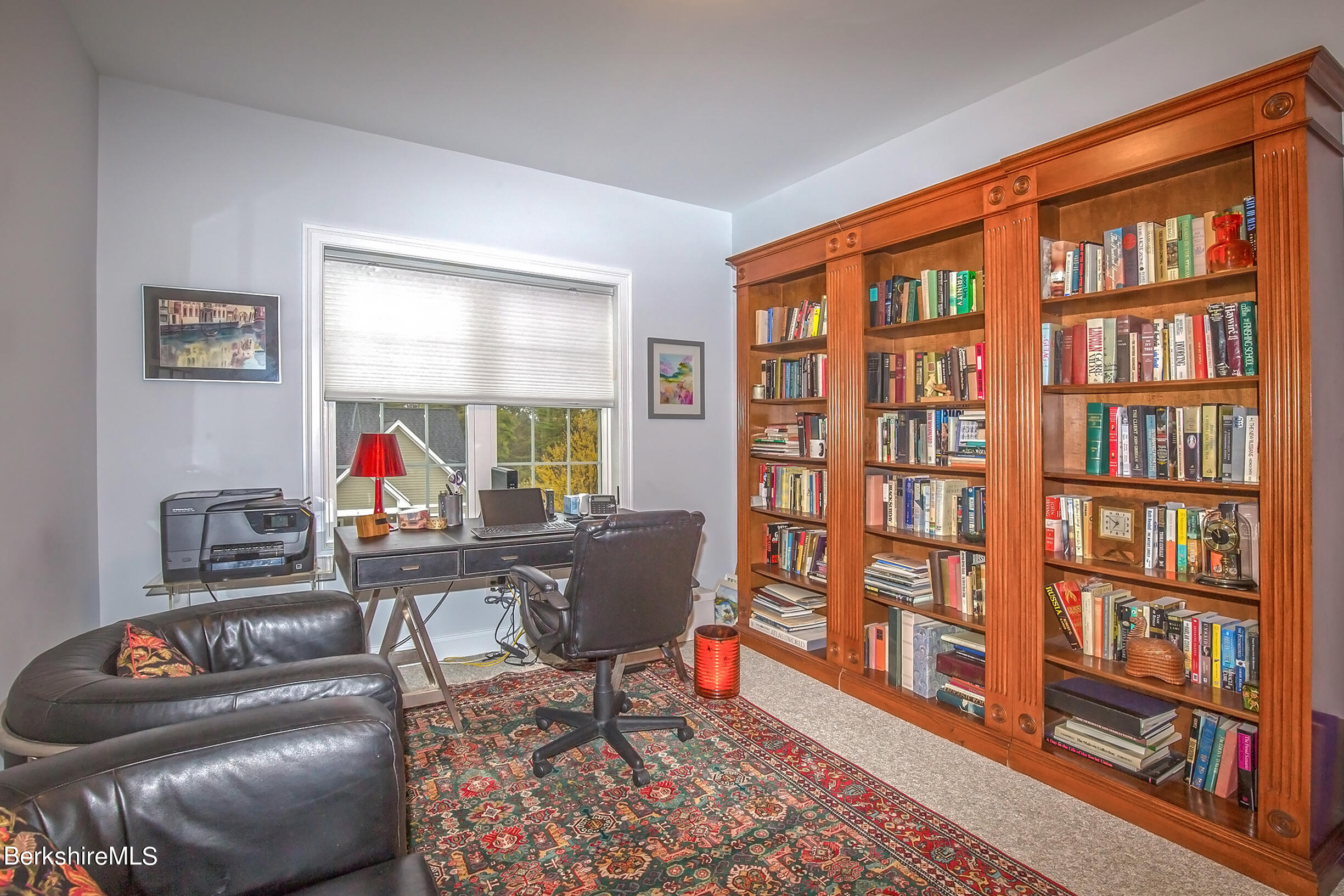 3 Burning Tree Road Great Barrington, MA 01230 - Photo 28 of 50 a living room with furniture a bookshelf and a window
