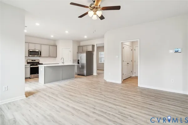 a view of a kitchen with a sink and a refrigerator
