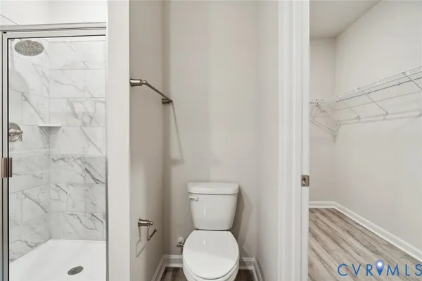 a bathroom with a toilet and a shower