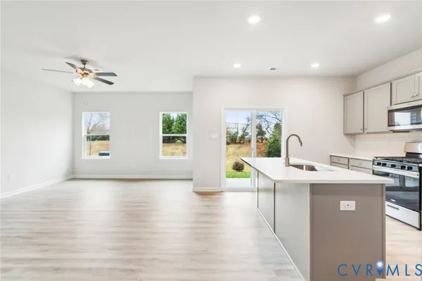 a view of a kitchen with a sink cabinets and wooden floor
