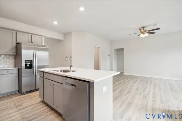a kitchen with a sink and refrigerator