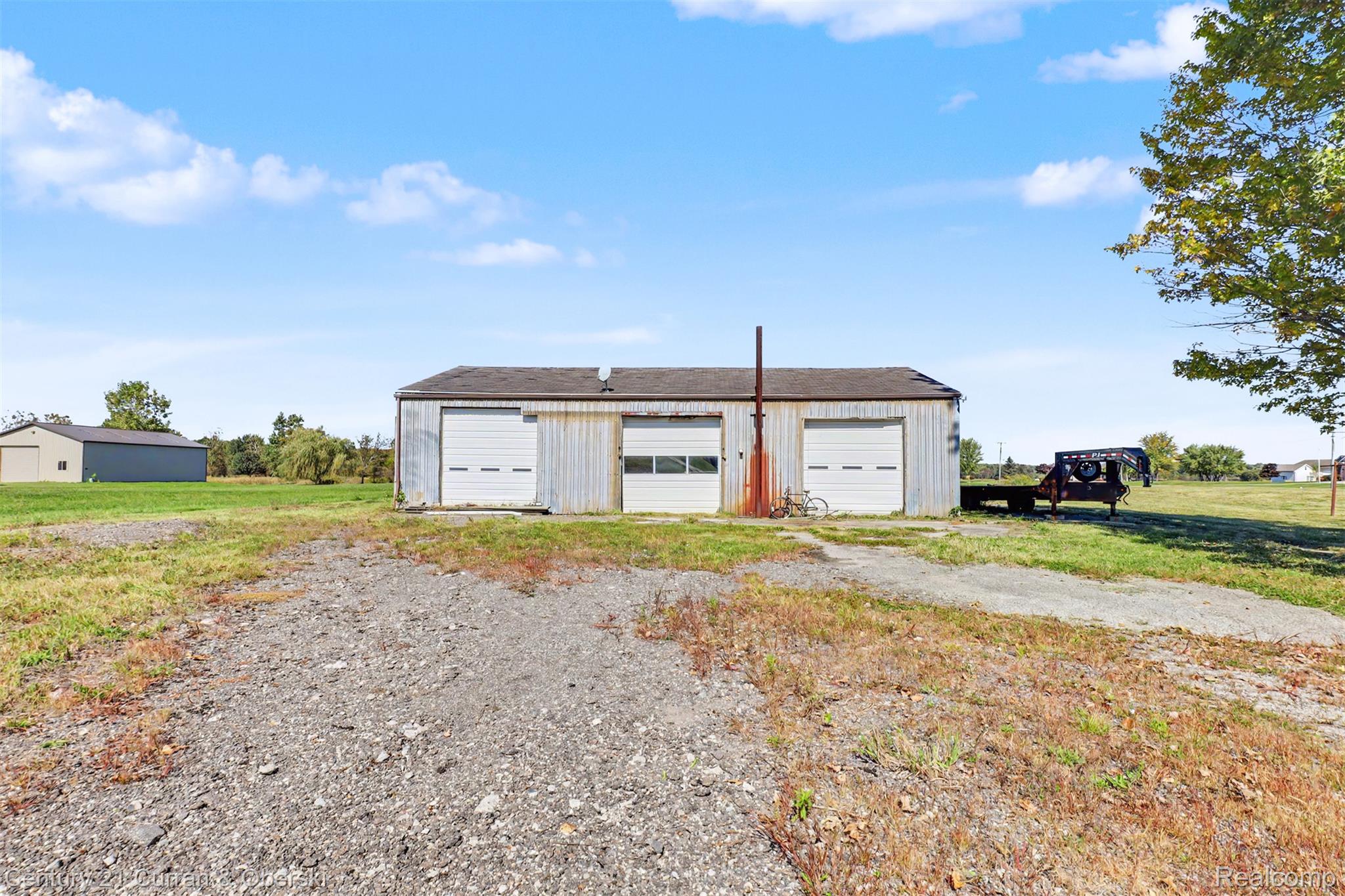 7504 Meisner Road Casco, MI 48064 - Photo 15 of 27 Metal-sided structure with multiple roll-up garage doors