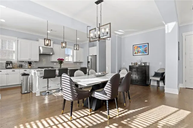 a view of a dining room with furniture wooden floor and chandelier