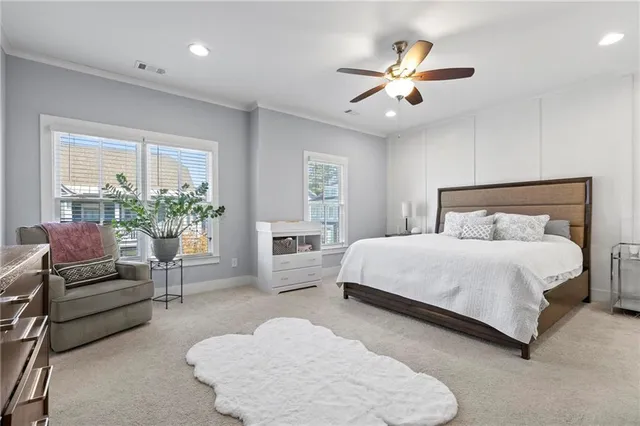 a bedroom with a large bed and potted plant