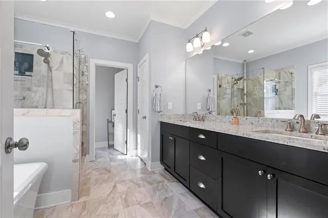 a spacious bathroom with a double vanity sink mirror and shower