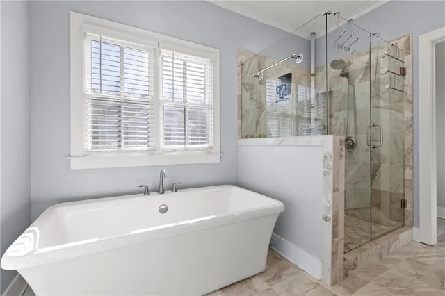a white bath tub sitting next to a shower