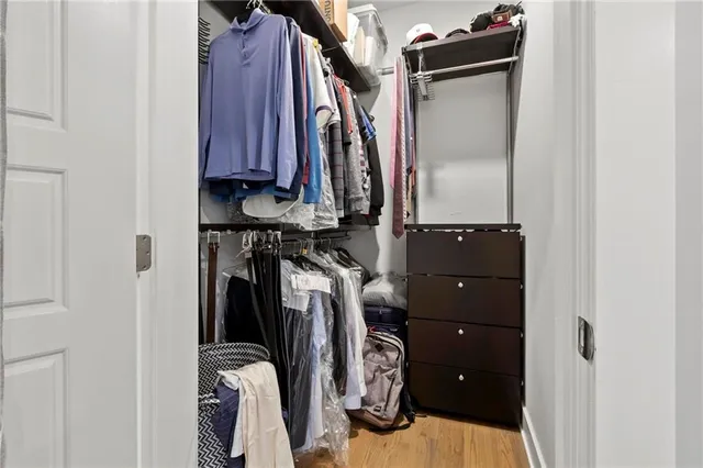 a view of walk in closet with clothes