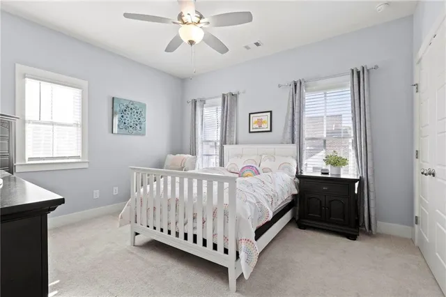 a bed sitting in a bedroom next to a window