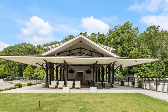 a view of a house with swimming pool and sitting area