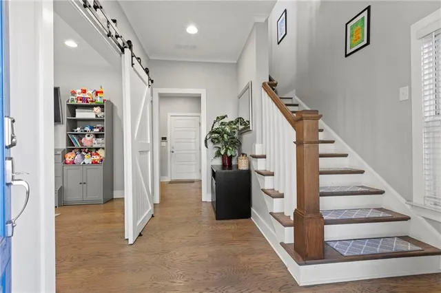 a view of entryway with furniture and wooden floor