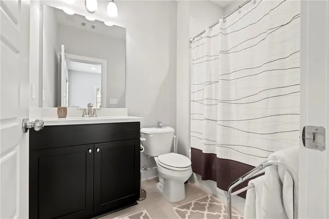 a bathroom with a sink toilet and vanity