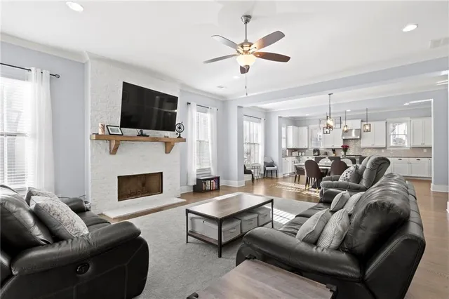 a living room with furniture a flat screen tv and a fireplace