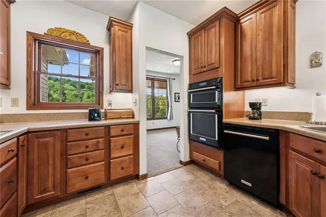 a kitchen with stainless steel appliances granite countertop a refrigerator and a sink